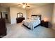 Spacious main bedroom with carpet, dark wood furniture, and shuttered windows at 25935 W Potter Dr, Buckeye, AZ 85396