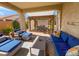 Outdoor patio area with comfortable blue cushioned seating, a pergola and an outdoor dining area at 25935 W Potter Dr, Buckeye, AZ 85396