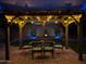 Outdoor patio area with romantic string lights and dining table at 25935 W Potter Dr, Buckeye, AZ 85396