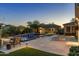 Expansive backyard with a sparkling pool, spa, casita, lush landscaping, and lounge chairs for ultimate relaxation at 26099 N 88Th Way, Scottsdale, AZ 85255