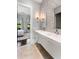 Modern bathroom featuring double vanity sinks, a large mirror, and eye-catching mosaic tiling at 26099 N 88Th Way, Scottsdale, AZ 85255