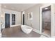 Bright bathroom featuring a modern soaking tub, neutral wall art, and a step-in shower at 26099 N 88Th Way, Scottsdale, AZ 85255