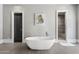 Bright bathroom featuring a modern soaking tub, neutral wall art, and a step-in shower at 26099 N 88Th Way, Scottsdale, AZ 85255