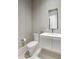 Modern bathroom featuring a toilet, vanity, sink, and minimalist mirror at 26099 N 88Th Way, Scottsdale, AZ 85255