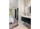 Modern bathroom with floating vanity, sleek mirror, and a view to the bedroom with natural light at 26099 N 88Th Way, Scottsdale, AZ 85255