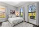 Bright bedroom featuring two large windows, an abstract art piece, and a soft, neutral color palette at 26099 N 88Th Way, Scottsdale, AZ 85255