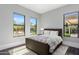 Bright bedroom with views to backyard, large windows, and comfortable furniture at 26099 N 88Th Way, Scottsdale, AZ 85255