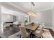 Open dining room features a chandelier and a view into the living room at 26099 N 88Th Way, Scottsdale, AZ 85255