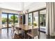 Open dining room with dark wood floors, backyard views, and modern chandelier at 26099 N 88Th Way, Scottsdale, AZ 85255
