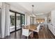 Spacious dining room featuring a large wooden table and sliding glass doors leading to the patio at 26099 N 88Th Way, Scottsdale, AZ 85255