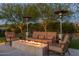 Inviting outdoor seating area with a cozy fire pit, surrounded by manicured landscaping and heaters at 26099 N 88Th Way, Scottsdale, AZ 85255