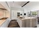 Modern kitchen featuring a large island with sink, sleek white cabinetry, and stainless steel appliances at 26099 N 88Th Way, Scottsdale, AZ 85255
