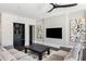 Comfortable living room with large sofa, modern decor, built-in shelves and wall-mounted TV at 26099 N 88Th Way, Scottsdale, AZ 85255