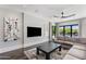 Bright living room with backyard views, comfortable seating, stylish decor, and access to outdoor area at 26099 N 88Th Way, Scottsdale, AZ 85255