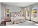 Serene main bedroom with large bed, soft lighting, and windows with backyard views at 26099 N 88Th Way, Scottsdale, AZ 85255