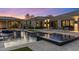 Inviting pool area with luxurious lounge chairs and elegant outdoor lighting at dusk at 26099 N 88Th Way, Scottsdale, AZ 85255