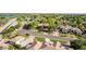 Expansive aerial view of a meticulously landscaped property with a serene lake nearby at 2641 E Birchwood Pl, Chandler, AZ 85249