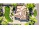 Expansive aerial view of a house featuring a putting green, tiled roof, and meticulously landscaped surroundings at 2641 E Birchwood Pl, Chandler, AZ 85249