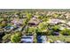 Gorgeous aerial view showcasing the home's backyard, tennis courts, pool and lush landscaping at 2641 E Birchwood Pl, Chandler, AZ 85249