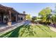 Sprawling backyard with covered patio, lush lawn and desert landscaping, perfect for outdoor living at 2641 E Birchwood Pl, Chandler, AZ 85249