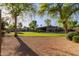 Beautiful backyard with lush green lawn, mature trees, and gravel area, creating a serene outdoor space at 2641 E Birchwood Pl, Chandler, AZ 85249