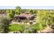 Aerial view of the backyard featuring desert landscaping, mature trees, and ample room for outdoor activities at 2641 E Birchwood Pl, Chandler, AZ 85249
