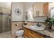 Bathroom showcasing granite counters, wood cabinets, tile surround shower and neutral walls at 2641 E Birchwood Pl, Chandler, AZ 85249