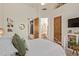 Bright bedroom featuring white walls, ceiling fan, and charming details throughout at 2641 E Birchwood Pl, Chandler, AZ 85249