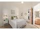 Cozy bedroom with a white iron bed frame and neutral decor with access to the ensuite bathroom at 2641 E Birchwood Pl, Chandler, AZ 85249