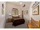 Bedroom with neutral walls, wood bench, wood night stands and natural light at 2641 E Birchwood Pl, Chandler, AZ 85249