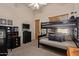 Neutral bedroom offering a bunk bed, sewing machine desk and dark wood furnishings at 2641 E Birchwood Pl, Chandler, AZ 85249
