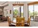 Bright breakfast nook with views from large windows, seating four around a copper top table at 2641 E Birchwood Pl, Chandler, AZ 85249