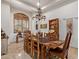 Charming dining room featuring a rustic wooden table, chandelier, and stylish window shutters at 2641 E Birchwood Pl, Chandler, AZ 85249
