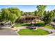An inviting single-story home featuring lush landscaping, a circular driveway, and a grand entrance at 2641 E Birchwood Pl, Chandler, AZ 85249