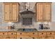 Modern kitchen with granite countertops, stainless steel appliances, tile backsplash, and custom wooden cabinets at 2641 E Birchwood Pl, Chandler, AZ 85249
