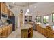 Open-concept kitchen with granite countertops, stainless steel appliances, and custom wooden cabinets at 2641 E Birchwood Pl, Chandler, AZ 85249