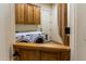Functional laundry room showing a washer/dryer unit with built in storage cabinets above at 2641 E Birchwood Pl, Chandler, AZ 85249