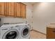 Well-equipped laundry room featuring a modern washer and dryer and ample storage space at 2641 E Birchwood Pl, Chandler, AZ 85249