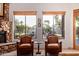 Cozy living area with large windows offering scenic views and comfortable armchairs near fireplace at 2641 E Birchwood Pl, Chandler, AZ 85249