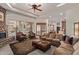 Spacious living room featuring a stone fireplace, plush sofas, and abundant natural light at 2641 E Birchwood Pl, Chandler, AZ 85249