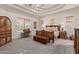 Expansive main bedroom featuring a decorative tray ceiling and quality wooden furniture at 2641 E Birchwood Pl, Chandler, AZ 85249