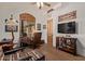 Home office with wood-paneled window, wooden desk, decorative lighting, and mounted TV at 2641 E Birchwood Pl, Chandler, AZ 85249