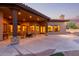 Covered patio perfect for entertaining with outdoor furniture and a cozy fireplace in the distance at 2641 E Birchwood Pl, Chandler, AZ 85249