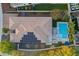 Aerial view of a home featuring solar panels, a pool, and outdoor entertaining area in a well-maintained neighborhood at 26879 N 100Th Ln, Peoria, AZ 85383