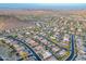 Panoramic aerial view of a desert community featuring winding streets and homes nestled amidst mountains and vast landscapes at 26879 N 100Th Ln, Peoria, AZ 85383