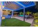 Stylish backyard with a covered patio, outdoor kitchen, and a sparkling pool view at 26879 N 100Th Ln, Peoria, AZ 85383