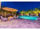 Inviting backyard boasts a stunning pool, fire pit, and shaded seating, perfect for relaxation and entertaining under the stars at 26879 N 100Th Ln, Peoria, AZ 85383