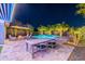 Backyard patio area with dining table, patio furniture, fire pit and refreshing swimming pool at 26879 N 100Th Ln, Peoria, AZ 85383