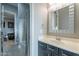 Clean bathroom with a modern vanity, mirror, and walk-in shower with shower curtain at 26879 N 100Th Ln, Peoria, AZ 85383