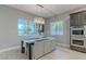 Elegant dining room with a modern chandelier, large windows, and convenient access to the kitchen at 26879 N 100Th Ln, Peoria, AZ 85383